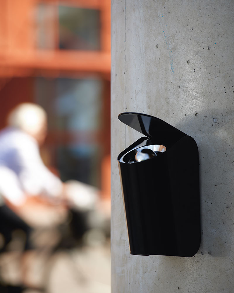 Ashtray attached to the side of a business building for smokers.